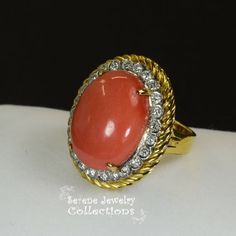 Thank you for coming in! Pretty orange red Coral diamond Vintage 14k yellow gold Ring! The coral is in an oval shape and is surrounded by sparkly white round diamonds. Ring Size: 6.25Total Weight: 12 gramsPrecious Metal: 14k solid goldPrecious stones:-Coral Center Stone: 20.1mm x 15mm, 14.2 carats-White Round diamonds: 0.73 caratsHallmark: 585, 14k Elegant Oval Coral Rings, Elegant Coral Oval Rings, Oval Orange Diamond Jewelry, Red Oval Diamond Ring With Pave Setting, Red Oval Jewelry With Pave Setting, Oval Red Jewelry With Pave Setting, Elegant Oval Coral Jewelry, Elegant Coral Oval Jewelry, Coral Oval Jewelry For Weddings