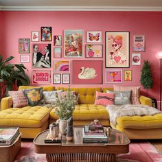 a living room filled with yellow couches and pictures on the wall above them,