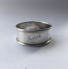 a silver ring with the word julia engraved on it's side, sitting on a white surface