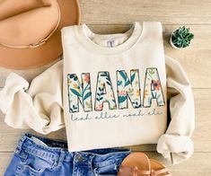 Mother's Day Gift Grandma Gift Personalized Sweatshirt Nana Custom Sweater New Grandma Gifts Baby Announcement Pregnancy Reveal Nana Shirt Whether it's a birthday, Mother's Day, or just a thoughtful surprise, this personalized sweatshirt makes for a heart-touching gift for grandmothers who hold their grandchildren close to their hearts. Personalize this sweatshirt with the names of your grandma's or Nana's pride and joy - her grandchildren!  These make a great gift for new Grandmothers, Nana, and Gigi's! Great for Christmas gifts, Mother's Day gifts, baby shower gifts or baby announcement gifts!  How to Order: -Browse our selections of styles and colors -Reference the sizing chart  -Choose your color/size from the drop down menus -Type your personalization in the box provided - double chec Womens Fall Sweaters, Tailor Made Shirts, Graphic Tee Women, Fall Graphic Tee, Design For Shirt, Fall Sweaters For Women, Sweaters Fall, Self Love Club, Fall Graphic