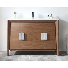 a bathroom vanity with two sinks and a towel rack on the wall next to it