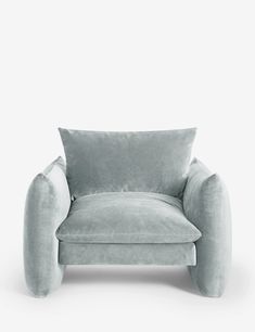 a grey chair with a pillow on it's back and arms, in front of a white background