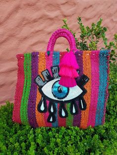 a colorful bag with an eye on it