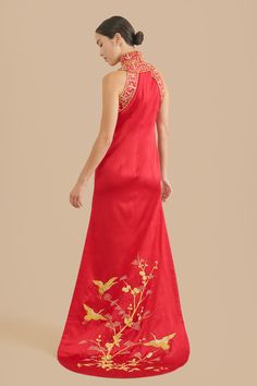 Say hello to your inner warrior princess while wearing this one-of-a-kind, hand embroidered Chinese wedding cheongsam dress. Admire the intricate, yet dramatic high mandarin collar paired with a modern halter top. Zoom in to see the elegant hand-embroidered cranes delicately sewn throughout the body and train of the qipao. If Mulan had a powerful outfit for her Chinese wedding, this would be it. Pair this with our Ruby hairpin to fully unleash all the power and beauty within you. Check out addit Fitted Dress With Gold Embroidery For Ceremony, Ceremonial Fitted Embroidered Dress, Ceremonial Dresses With Floral Embroidery, Embroidered Fitted Cheongsam For Ceremonies, Embroidered Ao Dai For Traditional Ceremonies, Ceremonial Fitted Dress With Floral Embroidery, Ceremonial Fitted Floral Embroidery Dress, Sleeveless Ao Dai For Wedding, Traditional Cheongsam For Ceremony