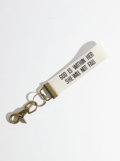 a keychain that says, god is within her she will not fall