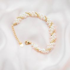 This beautiful bracelet features three layers of delicate baby pearls, delicately strung on a gold plated chain. The bracelet is accented with gold beads, adding a touch of luxury to the piece. The perfect accessory for any occasion, this bracelet will add a touch of elegance to any outfit. The pearls are of highest quality, lustrous and of round shape, perfect for everyday wear or as a special gift. Pearl Type: Freshwater Pearls Pearl Quality: [Shape]: Round [Pearl Size]: 3-4mm [Blemish]: Minim Adjustable Gold Pearl Chain Bracelet, Elegant Pearl Beaded Bracelets With Tiny Beads, Gold Multi-strand Beaded Bracelet As Gift, Elegant Pearl Beaded Bracelet With Tiny Beads, Dainty Pearl Beaded Bracelets For Party, Delicate Gold Chain Bracelet With Pearls, Pearl Beaded Bracelets With Round Beads, Pearl Chain Beaded Bracelets, Pearl Bracelets With Tiny Beads For Wedding