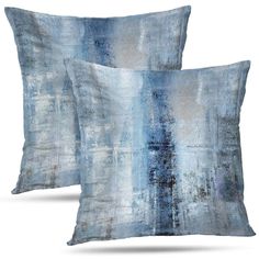 two pillows with blue and white designs on them