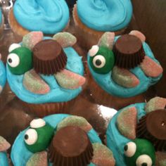 cupcakes decorated with blue frosting and brown icing in the shape of animals