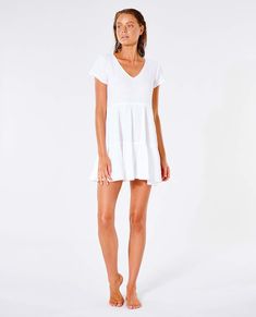 The Premium Surf Dress will be a staple piece for your collection this summer. Perfect to throw over bikinis or to dress up for a night out. Made in a relaxed fit and finished with shirring detail. Features: 100% cotton, Relaxed fit, Inner neck label, Metal logo trim, Shirring detail Model Wears Model is 176 cm (5'8) and wearing a size XS. Beachy V-neck Mini Dress For Poolside, Casual White Beach Dress For Poolside, Relaxed Fit V-neck Mini Dress For Vacation, Summer V-neck Mini Dress With Relaxed Fit, Relaxed Fit V-neck Mini Dress For Summer, White V-neck Poolside Dress, White V-neck Dress For Poolside, Relaxed Fit Mini Dress For Summer Day Out, Cotton V-neck Beach Dress For Day Out