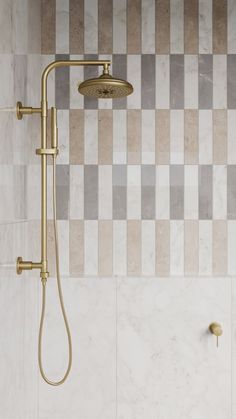 a shower head with thermostaer and hand held shower faucet in front of a tiled wall