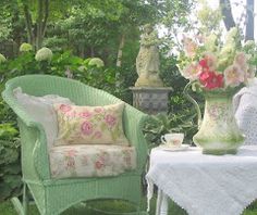 two chairs and a table with flowers in vases