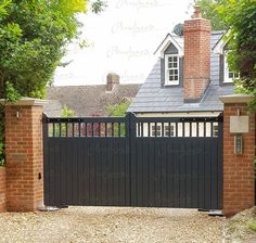 a black gate is in front of a brick house