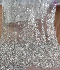 Price: The price is for 1 yard. if you buy more than 1 yard ,it won't be cut. will come in one piece the longest is 20 yards. Material: polyester,pearls,sequins,beads Fixed Wide : 125cm or 49 inches. color:off white,silver Want to see other colors and more similar Beading lace fabrics come to: https://www.etsy.com/shop/Randyfabrics?ref=hdr_shop_menu&section_id=14192305 Shipping: Choose the shipping way you need, if you want package shipped by express,please note the phone number on order. Us Silver Embroidered Fitted Fabric For Wedding, Fitted Silver Embroidered Fabric For Wedding, Silver Lace Embroidered Fabric For Wedding, Elegant Silver Embroidered Fabric With Lace Work, Fitted Silver Lace For Party, Elegant Silver Lace With Sequins, Elegant Silver Lace With Intricate Embroidery, Silver Lace Tulle Fabric For Wedding, Silver Lace With Lace Work For Party