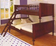 a wooden bunk bed sitting on top of a hard wood floor next to a window