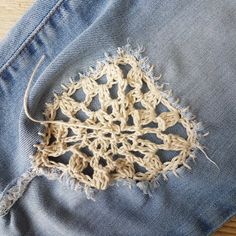 an old pair of jeans with crochet on them