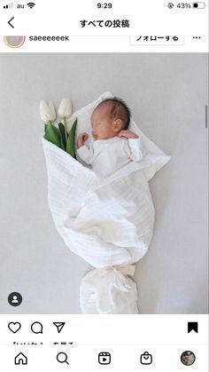 a baby wrapped in a blanket with tulips on it's side and the caption is japanese