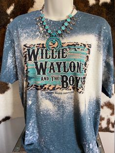 Saddle up and show off your love for country life with our Willie, Waylon and The Boys Graphic Tee! This unisex jersey short-sleeve tee is the perfect addition to your wardrobe. Made from a super soft cotton blend, it feels like a well-loved favorite from the moment you put it on.  With its excellent quality print, this tee is sure to catch the eye of fellow rodeo enthusiasts and fans of the Western lifestyle. Whether you're hitting the ranch or heading to a country concert, this tee will have you looking stylish and feeling comfortable all day long. Our Willie, Waylon, and The Boys Graphic Tee is proudly custom-made at our facility in the USA, ensuring top-notch quality. The tear-away tag adds an extra level of convenience, while the light fabric guarantees breathability even during those Fall Letter Print T-shirt For Country Concerts, Graphic Print Crew Neck T-shirt For Country Concerts, Summer Graphic Print T-shirt For Country Events, Cotton Crew Neck T-shirt For Country Events, Vintage Short Sleeve T-shirt For Country Concerts, Country Style Crew Neck Top With Graphic Print, Graphic Tee With Letter Print For Country Festivals, Country Style Graphic Print Tops For Summer, Cotton T-shirt With Letter Print For Country Festivals