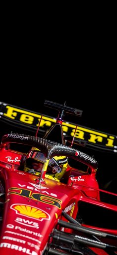 a red race car driving on a track