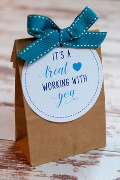 it's a great working with you gift card in a brown paper bag on a wooden table