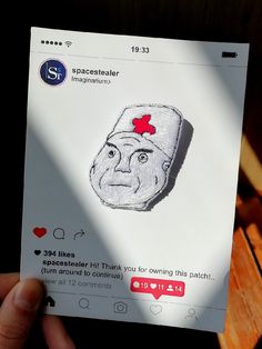 someone is holding up a paper with an image of a man's face on it