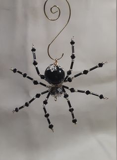 a black and white spider ornament hanging from a hook