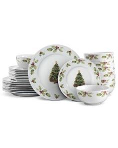 a stack of christmas plates with holly tree designs on the front and side, stacked next to each other