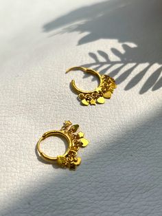 Handmade and Handcrafted Designer Tiny 22karat Solid Gold Hoops. Decorated with tiny small gold balls. Hallmarked Gold hoop, Tested and Hallmarked in Indian Gold Testing Lab. Metal: 22k Gold Weight: 2.21 Milligrams Location: Earlobe, Tragus and Cartilage Wire Goes in ear: fits in normal Piercing Size We will send this order by standard shipping, For the US it will take 8-24 days to deliver. Other countries take 3-4 weeks. Jewelry comes in a beautiful g ift box and Silk box. Adorable Christmas g ift for your loved ones. Gold Small Hoop Earrings, Gold Nose Stud, Helix Hoop, 22k Gold Jewelry, Handmade Gold Jewellery, Lobe Piercing, Small Hoop Earrings, Nose Jewelry, Indian Earrings