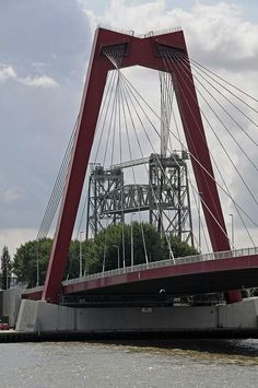 a red and white bridge spanning the width of a body of water