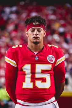 a close up of a football player wearing a bandana on his head and looking at the camera