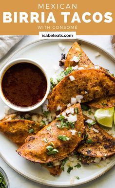 mexican burritos on a plate with salsa and lime wedges next to them