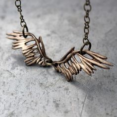 An elegant yet rustic and edgy necklace featuring sculpted wings with a skeletal feeling to them. I sculpted these wings inspired by the hauntingly beautiful and tragic pictures (by Nick Brandt) of petrified birds. Unsuspecting animals that choose lake Natron in Tanzania as a resting place end up staying there eternally. Chemicals in the water turn them to stone. The last picture shows the wings and the photos I was inspired by.The wings are carved with a feather pattern on both sides and are sl Tragic Pictures, Lake Natron, Nick Brandt, Unique Gold Wing-shaped Jewelry, Fantasy Silver Wing-shaped Jewelry, Bird Skull Jewelry, Gold Raven Skull Necklace, Raven Wing Necklace, Edgy Necklace