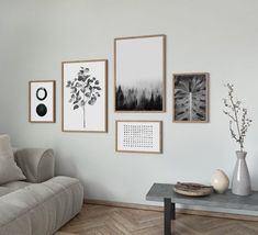 a living room filled with furniture and pictures on the wall next to a coffee table