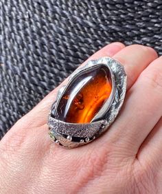 COGNAC AMBER RING in sterling silver Hand-made Sterling Silver. Size 7, can adjust to bigger size. Stones used: Baltic Amber, Green Tourmaline Face of the ring : Height - 43mm, Width-30mm Unique Handcrafted One-of a-kind Design Ring. Each Piece of Jewelry in my Collection is One of a kind. When you start wearing a piece of my jewelry you will fall in love with it more and more each day and feel that good energy that I pass into it while creating this piece of Art. I use only natural unique stone Unique Amber Rings For Formal Occasions, Artisan Amber Ring Jewelry, Artisan Amber Gemstone Rings, Formal Amber Rings, Unique Amber Sterling Silver Rings, Handmade Amber Sterling Silver Rings, Unique Amber Ring Jewelry, Unique Amber Ring, Unique Amber Open Ring