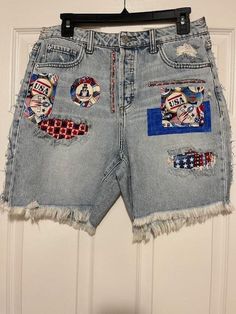 Upcycled Distressed Denim Shorts with patriotic fabric patches added. Patches added to front and back of shorts. Fashioned similar to @TMyer Upcycled clothing. 100% Cotton denim shorts.  Shorts are sourced and cleaned before upcycling. Size Small Waist: 30 inch  Hips: 38 inch Inseam: 1/2 inch Smoke Free home Ships to United States from Arkansas No Returns Casual Medium Wash Patchwork Jean Shorts, Casual Patchwork Jean Shorts In Medium Wash, Casual Medium Wash Patchwork Shorts, Summer Patchwork Cutoff Jean Shorts, Patchwork Cutoff Jean Shorts For Summer, Americana Style Denim Jean Shorts For Spring, Blue Patchwork Jean Shorts, Blue Patchwork Cutoff Shorts, Cotton Cutoff Jean Shorts For 4th Of July