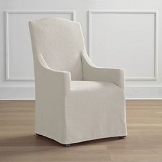 a white chair sitting on top of a hard wood floor