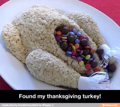 a white plate topped with rice krispy kreme turkey and candy bars on top of it