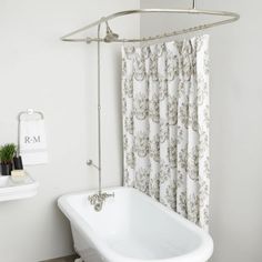 a white bath tub sitting next to a shower curtain