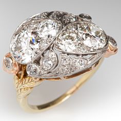 This stunning platinum topped yellow gold ring is bead set with four (4) round old European cut diamonds and accented with milgrain details. The top of the ring is bead and bezel set with a total of fourteen (14) antique round cut diamonds. The shoulders are each accented with a rose gold flower, bezel set with one (1) round single cut diamond. The ring measures 15.2mm at the top, rises 7.7mm above the finger, tapering to 1.3mm wide and 1.2mm thick at the base of the shank. It is currently a siz Luxury Fine Jewelry Diamond Ring With Bezel Setting, Antique Diamond Rings 1stdibs, Art Deco Diamond Ring, Deco Diamond Ring, Bijoux Art Nouveau, Diamond Girl, Jewellery Vintage, Antique Wedding Rings, Diamond Cocktail Ring