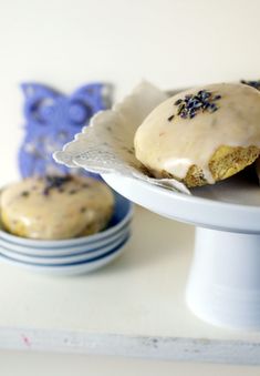 two donuts sitting on top of a white plate next to blue and white plates