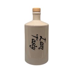 a white ceramic bottle with writing on it