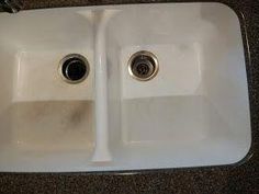 two white porcelain sinks sitting side by side