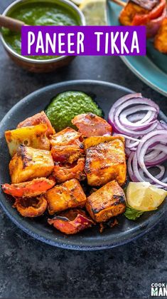 a plate with tofu, onions, and green sauce on it next to other food items