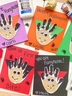 four handprinted cards with the words happy halloween written on them and some glue