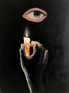 a person holding a lit candle in front of their face with an eye on it