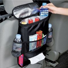 the back seat pocket is filled with drinks and water bottles, as well as an arm rest