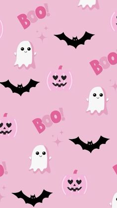 a pink background with black bats and white ghost faces on it's face, while the word boo is in front of them