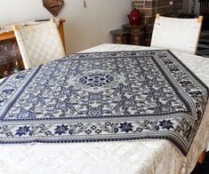 a bed with a blue and white bedspread sitting on top of it