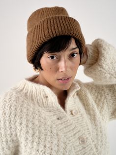 The OZMA Sweater Collection is made in Peru with the finest alpaca and wool yarns. All factories and yarn manufacturers are proudly Promperu Fair Trade Certified. A seasonal antidote to our beloved Bandana, our favorite beanie in this season's Caraveli yarn will keep you warm through any weather. Inspired by the cool alpine climate of the Sierra, the knitted accessory is luxury for the everyday. Classic Alpaca Sweater For Winter, Knitted Alpaca Hat For Fall, Cozy Alpaca Hats For Fall, Cozy Brown Merino Wool Outerwear, Cozy Merino Wool Hats For Fall, Casual Brown Alpaca Outerwear, Winter Knitted Recycled Wool Sweater, Soft Knit Merino Wool Hat For Fall, Warm Brown Wool Sweater