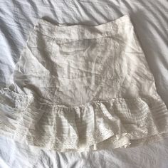 Size Small Elegant Flowy Mini Skirt For Vacation, White Fitted Feminine Mini Skirt, White Fitted Skirt For Vacation, Chic White Mini Skirt With Ruffles, White Ruffled Bottoms With Mini Hem, White Ruffled Mini Hem Bottoms, Chic Off-white Tiered Skirt, Elegant Spring Mini Skirt For Vacation, Chic Off White Tiered Skirt