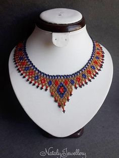 Red blue gold necklace Egyptian collar Egyptian jewelry Seed bead choker Gift for sister Unique gift Party accessory Statement necklace Gift for girlfriendthe width of the narrow part - 1.1 inches, the width of the central part - 2.5 inchesMaterials: Czech seed beads, bead thread, carbineRECOMMENDATION FOR USE AND CARE: - Keep your handmade jewelry in a closed box far away from sun rays access.- Do not clean with water and any other liquid.- Do not give them to small children.- Do not throw them Traditional Beaded Chain Choker, Traditional Tiny Beads Choker Necklace, Red Beaded Choker Necklace For Festivals, Gold Beaded Round Choker, Red Beaded Choker Necklaces For Festival, Festival Beaded Choker Necklace Gift, Festival Gift Beaded Choker Necklaces, Festival Gift Beaded Choker Necklace, Red Bead Choker For Festivals